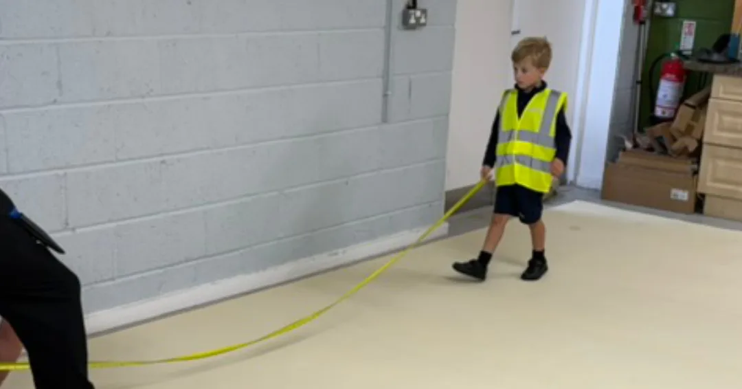 Ted Scott, holding a tape measure ready to help measure some new carpet, ready for cutting.
